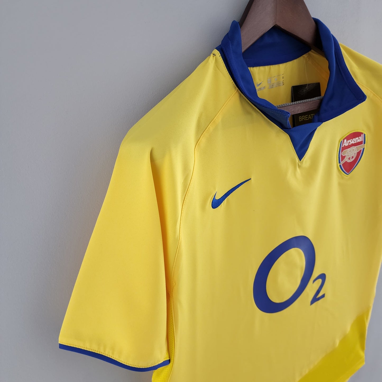 Arsenal “O2” 2004–05 — Camiseta away Nike amarilla (cuello azul)