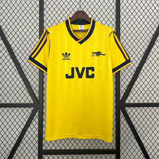 Arsenal “JVC” 1986–88 — Camiseta away Adidas amarilla (tres bandas)