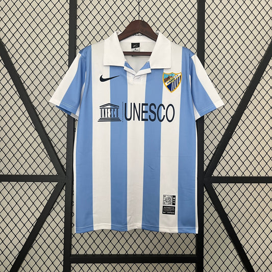 Málaga CF “UNESCO” 2012–13 — Camiseta home Nike celeste/blanca (cuello polo)